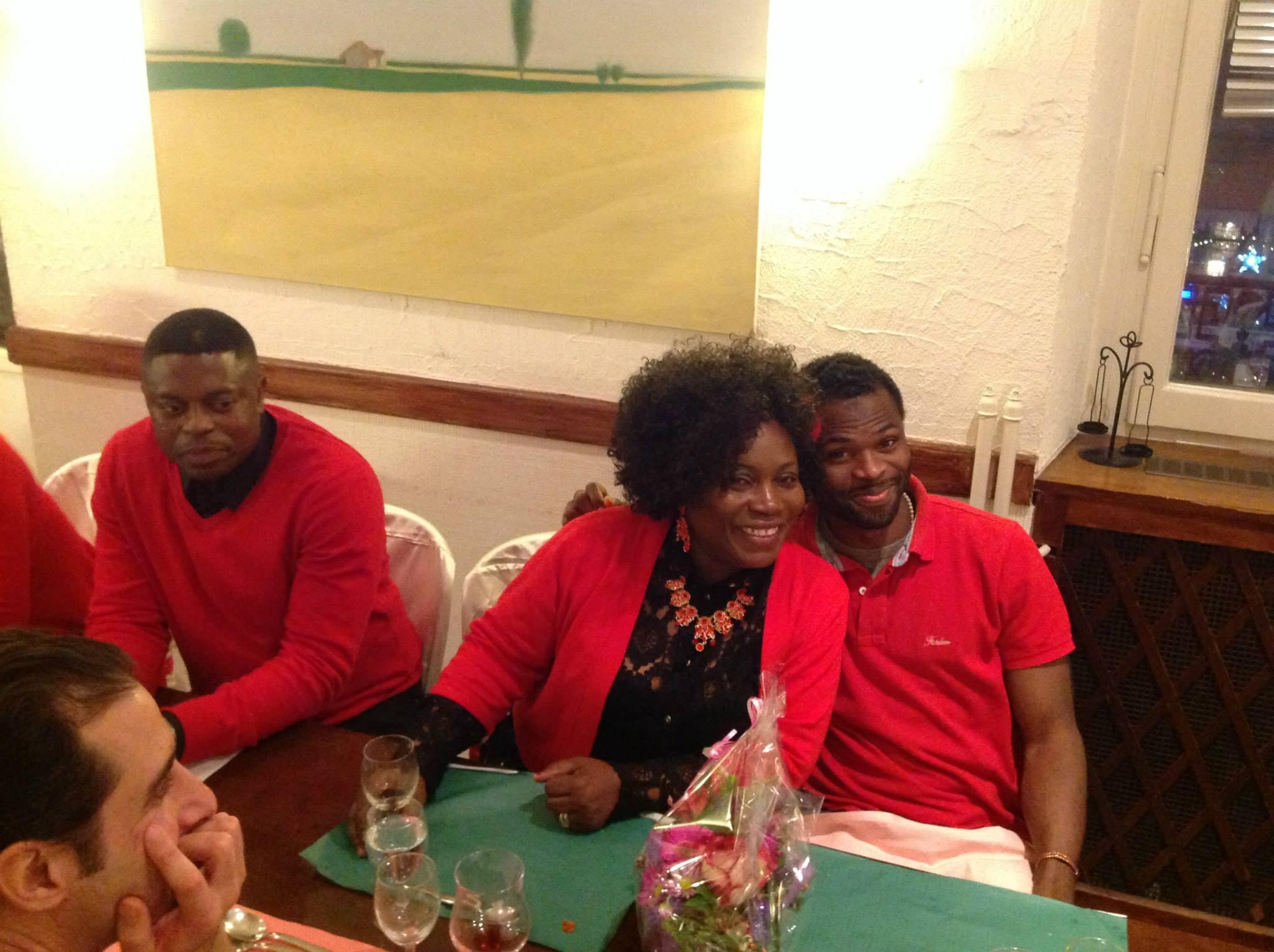 People posing for the camera at dinner table