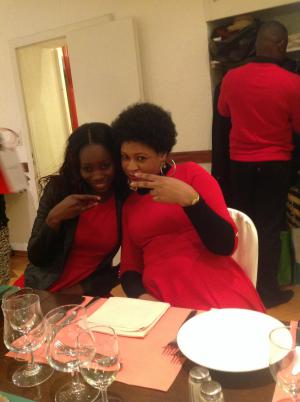 2 ladies in red posing for camera